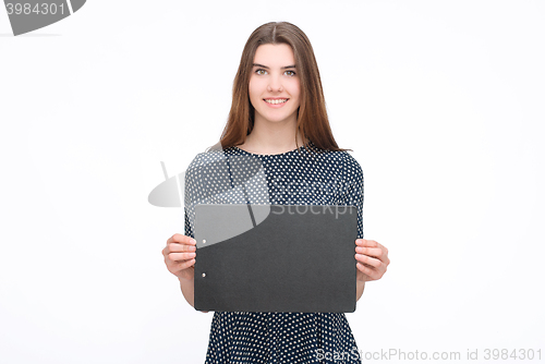Image of Young smiling woman show blank card or paper