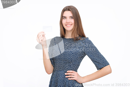 Image of Portrait of young smiling business woman holding blank card