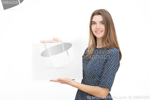 Image of Young smiling woman show blank card or paper