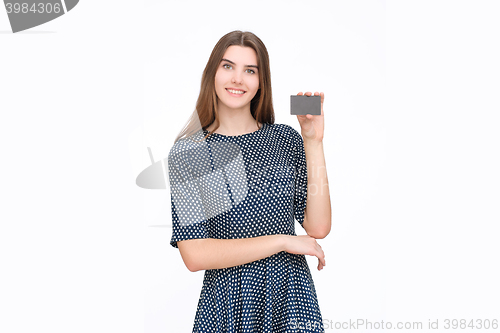 Image of Portrait of young smiling business woman holding credit card