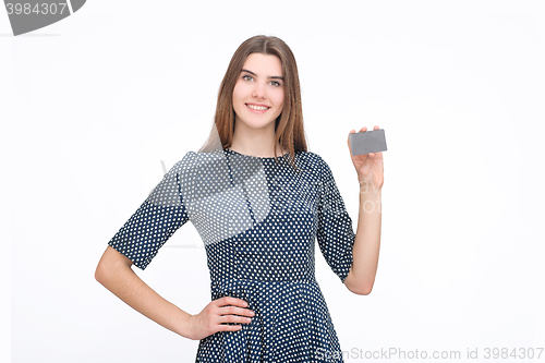 Image of Portrait of young smiling business woman holding credit card