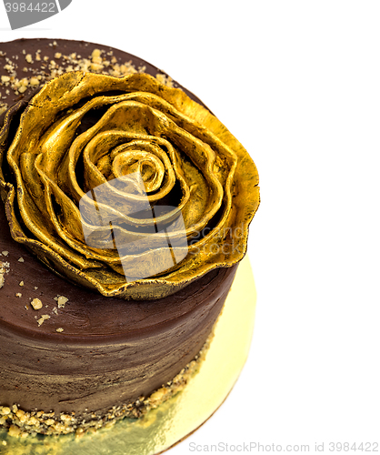 Image of Chocolate Cake Sprinkled with Crumbs and Golden Rose