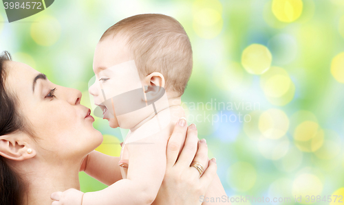 Image of happy mother kissing adorable baby