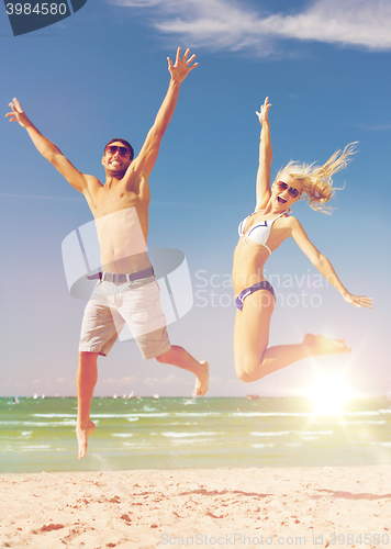 Image of couple jumping on the beach