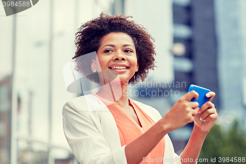 Image of happy african businesswoman with smartphone