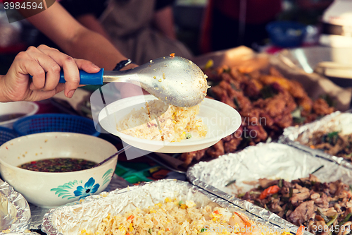 Image of close up of hands with wok at street market