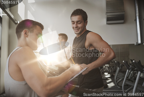 Image of men exercising on treadmill in gym