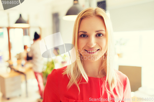 Image of happy creative woman at office or bureau