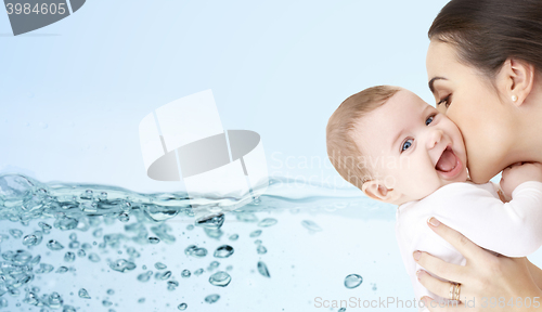 Image of happy mother kissing adorable baby