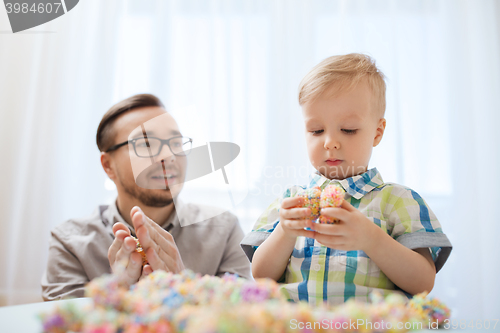 Image of father and son playing with ball clay at home