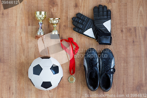 Image of ball, football boots, gloves, cups and medal