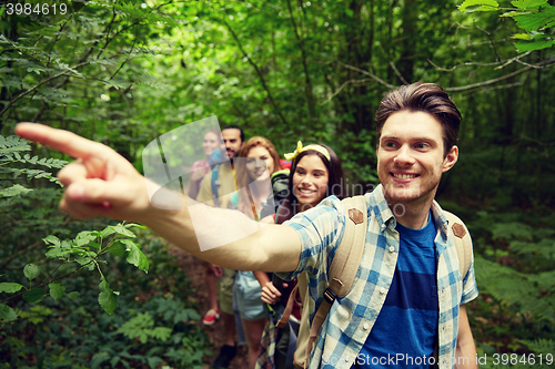 Image of group of smiling friends with backpacks hiking