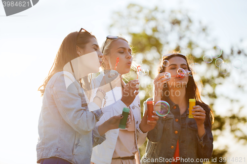 Image of young women or girls blowing bubbles outdoors