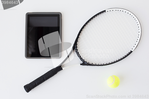 Image of close up of tennis racket with ball and tablet pc