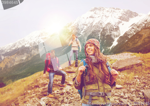 Image of group of smiling friends with backpacks hiking