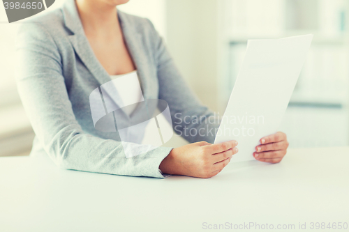 Image of close up of woman reading papers or tax report