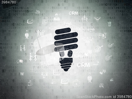 Image of Finance concept: Energy Saving Lamp on Digital Data Paper background