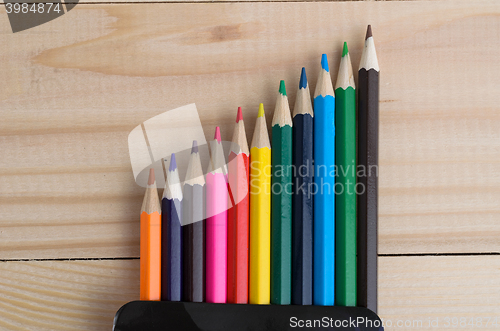 Image of Colored pencils on a wooden board