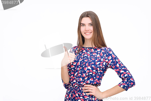 Image of Happy smiling beautiful young brunette woman showing thumbs up gesture