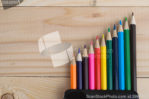 Image of Colored pencils on a wooden board