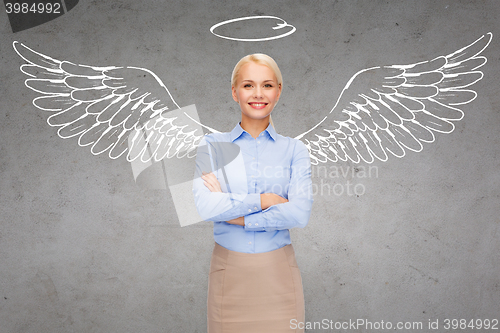 Image of happy businesswoman with angel wings and nimbus