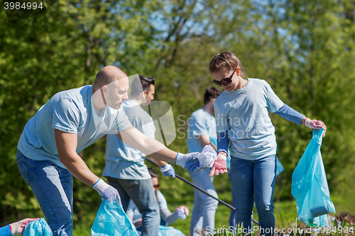 Image of volunteers with garbage bags cleaning park area