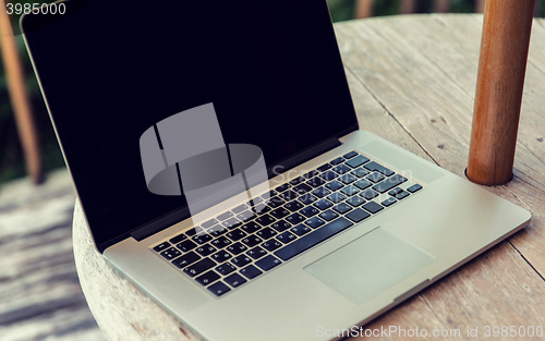 Image of close up of laptop computer on table at hotel