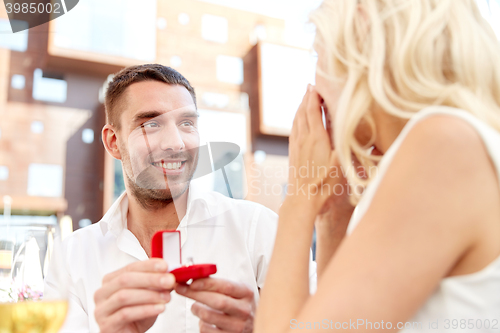 Image of man with engagement ring making proposal to woman