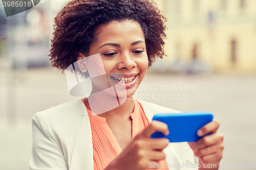 Image of happy african businesswoman with smartphone