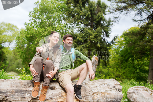 Image of smiling couple with backpacks in nature