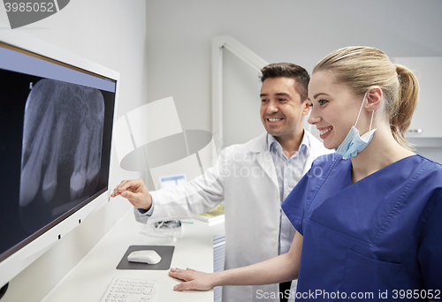 Image of dentists with x-ray on monitor at dental clinic