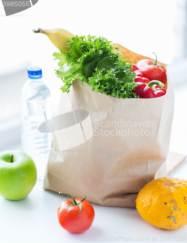 Image of close up of bag with friuts, vegetables and water