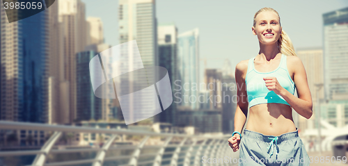 Image of woman running or jogging over dubai city street