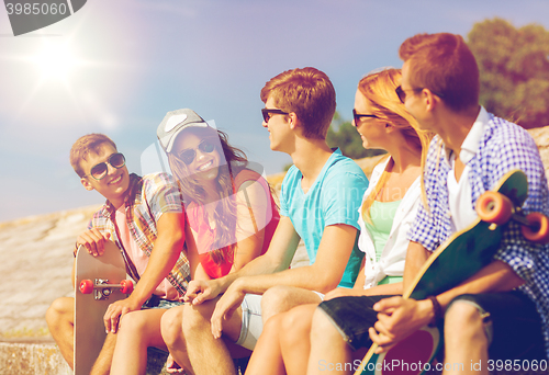 Image of group of smiling friends sitting on city street