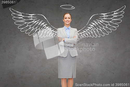 Image of happy businesswoman with angel wings and nimbus