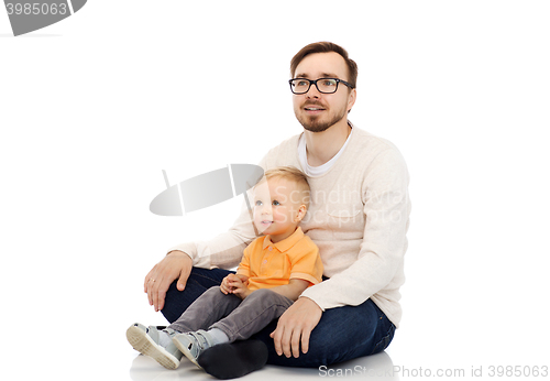 Image of happy father and little son sitting together