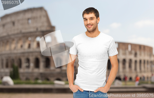 Image of happy man in blank white t-shirt over coliseum