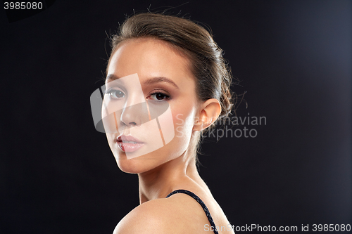 Image of beautiful young asian woman over black background