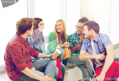 Image of students communicating and laughing at school