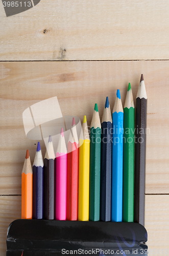 Image of Colored pencils on a wooden board