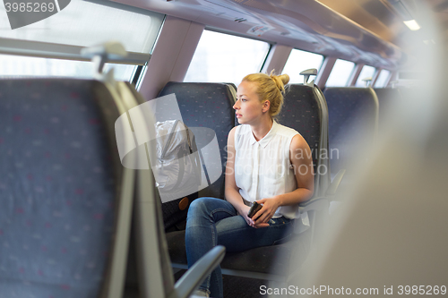 Image of Woman travelling by train.