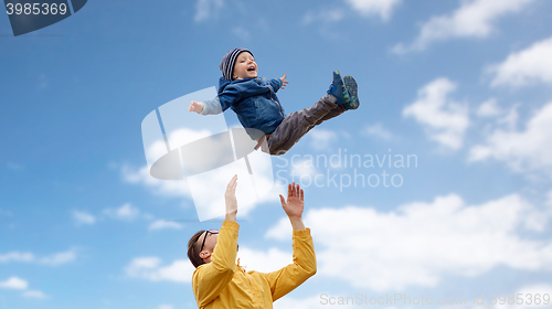 Image of father with son playing and having fun outdoors