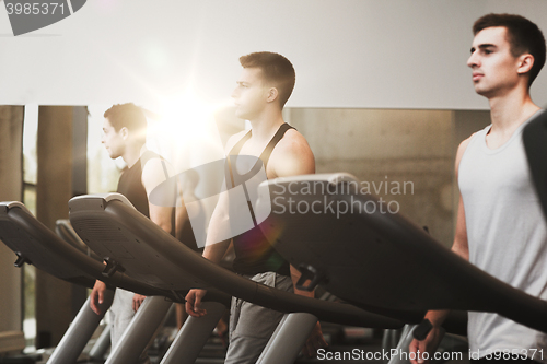 Image of group of men exercising on treadmill in gym