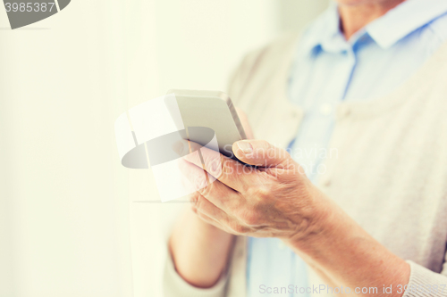 Image of close up of senior woman with smartphone texting