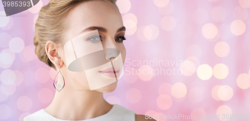 Image of smiling woman in white dress with pearl jewelry