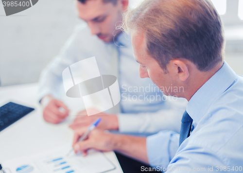 Image of businessmen with notebook on meeting