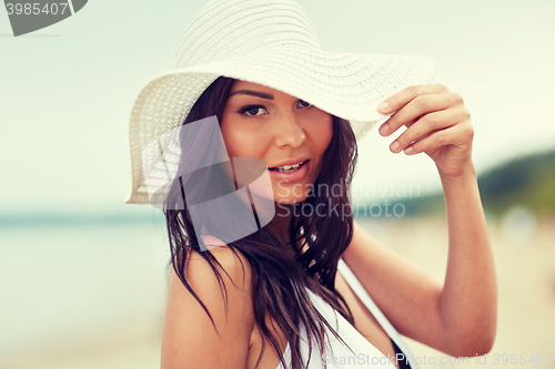 Image of happy young woman on beach