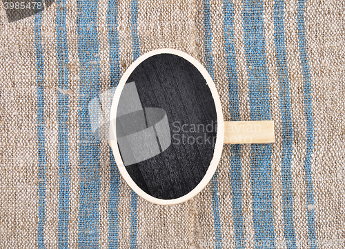 Image of Board with wooden peg on linen