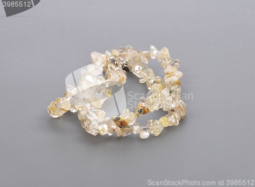 Image of Splintered rutile quartz chain on gray background