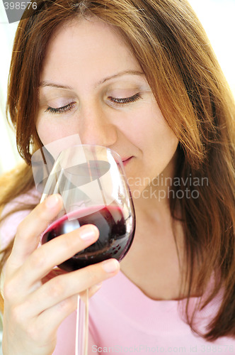 Image of Mature woman with a glass of red wine